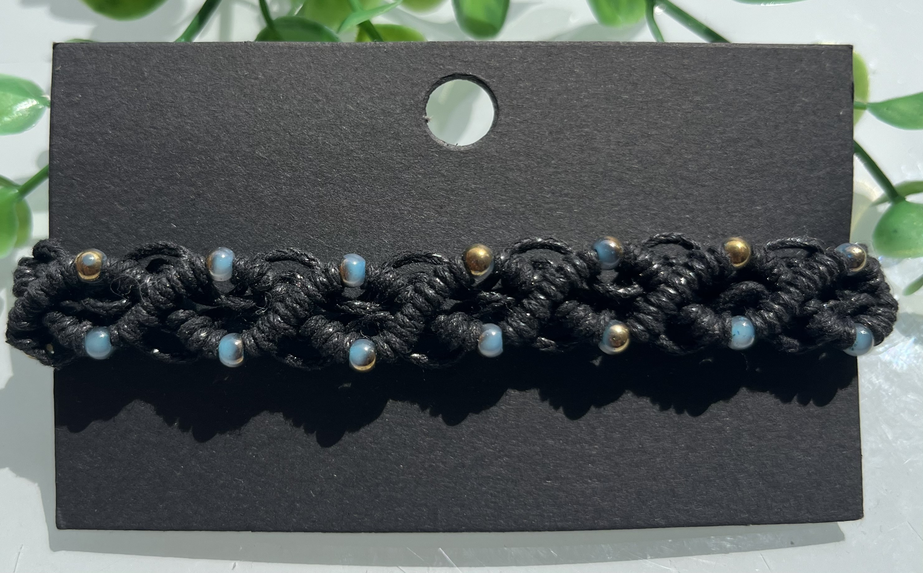 Golden macrame bracelet with woven structure and warm detailing